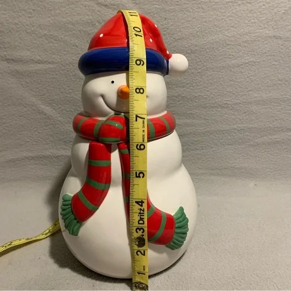 Holiday Snowman Cookie Jar with Santa’s red hat and red/green striped scarf. - Picture 2 of 8
